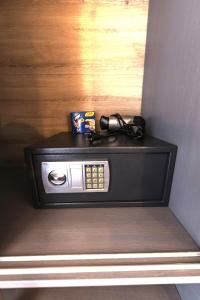 a black television with glasses on top of it at Aliston Hotel Thassos in Skala Potamias