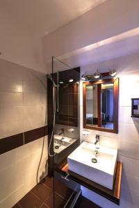 a bathroom with a white sink and a mirror at Aliston Hotel Thassos in Skala Potamias