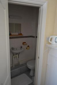 a bathroom with a toilet and a sink at Chandos Premier Folkestone (Channel Tunnel) Hotel in Folkestone