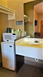 a kitchen with a sink and a microwave at La Copa Inn in McAllen