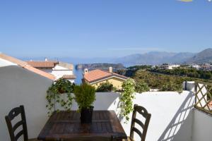 a table on the balcony of a house with a view at B&B Vistamar in San Nicola Arcella