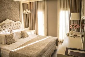 A bed or beds in a room at Ena Boutique Hotel