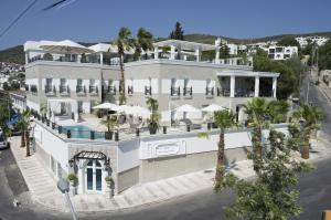 an aerial view of a large white building with palm trees at Ena Boutique Hotel in Bodrum City