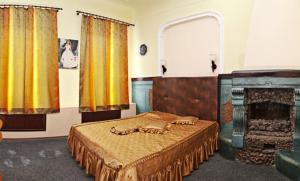 a bedroom with a bed and a fireplace at Margo Hotel in Kharkiv