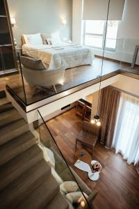 a bedroom with a bed and a glass floor at Filoxenion Luxury Rooms & Lofts in Nafplio