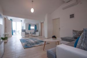 a living room with a couch and a table at Apartments Kuljace in Sveti Stefan