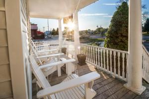 a wooden deck with a balcony overlooking a city at OurGuest Inn & Suites Downtown Port Clinton in Port Clinton