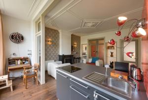 a kitchen and living room with a sink and a counter at Short stay Appartement Dependance Rotterdam in Rotterdam