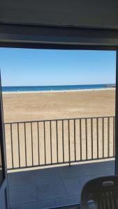 a view of the beach from a balcony of a beach at Les Corsaires direct plage près du port in Saint Pierre La Mer