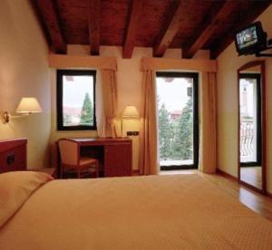 Postel nebo postele na pokoji v ubytování Hotel Ristorante Pedrocchi