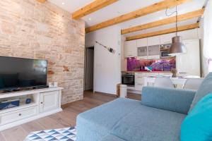 Et tv og/eller underholdning på Beach House Villa - Ap. 2