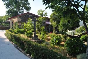 a house with a garden in front of it at Casa da Cruz in Vila Real