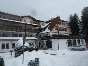 ein Haus mit einem Auto im Schnee in der Unterkunft Appartement Oberwiesenhof in Seewald