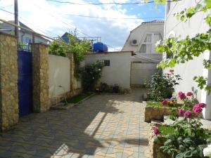 a courtyard in a house with flowers and plants at Dom on the seaside in Zatoka
