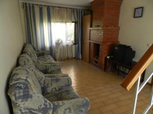 a living room with a couch and a fireplace at Dom on the seaside in Zatoka