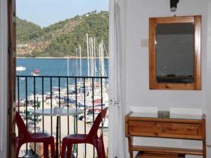 a room with a balcony with a view of a marina at Hotel Christina in Skiathos +24 photos