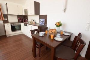a kitchen with a wooden table with chairs and a dining room at Hiddensee in Wiek auf Rügen