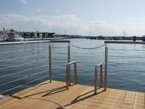 a dock with a chain on top of the water at Hiddensee in Wiek auf Rügen +3 photos