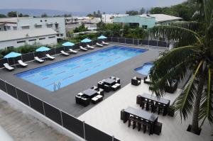 an overhead view of a swimming pool with chairs and tables at Luganvilla Business Hotel and Restaurant in Luganville