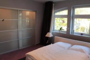 a bedroom with a white bed and a window at Duesternbrooker-Villa in Kiel