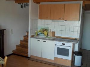 a kitchen with a sink and a stove top oven at Ferienwohnungen-Willrich-Ferienwohnung-3 in Blankenheim