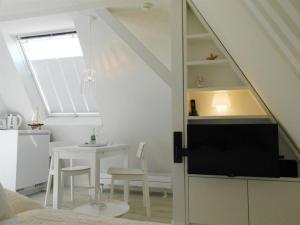 a living room with a table and a dining room at Haus-LIV-Appartement-Duene in Westerland