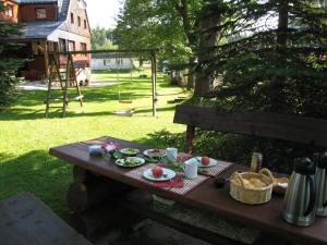 a picnic table with food on it in a yard at Ferienwohnung-3 in Hermsdorf