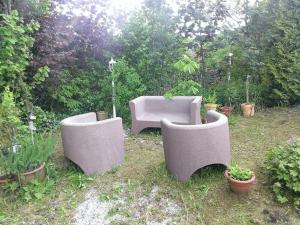 three cement chairs and a couch in a garden at Ferienwohnungen-Willrich-Ferienwohnung-3 in Blankenheim +13 photos