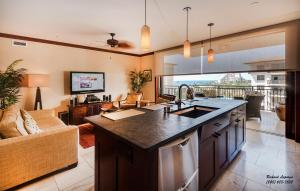 a kitchen with a sink and a living room at Beach Villas at Ko Olina 8th floor Ocean View in Kapolei