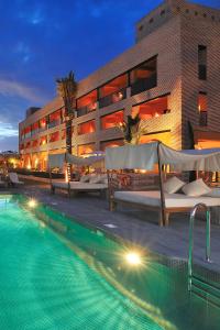 a hotel with a swimming pool in front of a building at Vincci Selección Estrella del Mar in Marbella