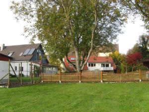 a wooden fence in front of a yard with houses at Nussbaum in Überlingen