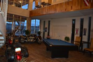 a room with a pool table and motorcycles in it at Travelodge by Wyndham Trinidad in Trinidad