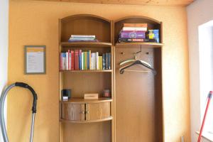 a book shelf with books on it in a room at Ferienwohnung-Zeller in Tengen