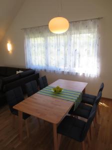 a dining room with a wooden table and chairs at Buche in Überlingen