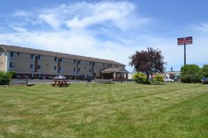 a large building with a picnic table in a field at Countryside Inn & Suites Omaha East-Council Bluffs IA in Council Bluffs