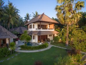 an aerial view of a house with a yard at Palm Garden Amed Beach & Spa Resort Bali in Amed