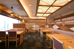a dining room with wooden tables and chairs at Shin Osaka Washington Hotel Plaza in Osaka +40 photos