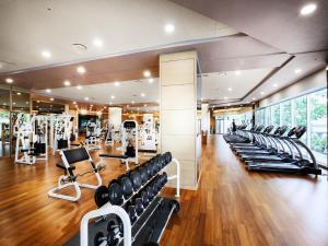 a gym with rows of treadmills and exercise equipment at Hotel Interburgo Daegu in Daegu