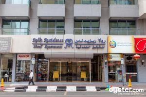 a man walking in front of a building at Rolla Residence Hotel Apartment in Dubai