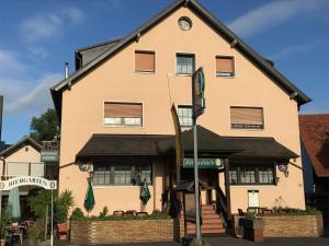 a building with a sign in front of it at Hotel Restaurant Alt Laubach in Laubach