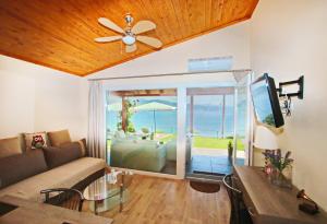 a living room with a couch and a view of the ocean at Kallithea in Iraklitsa