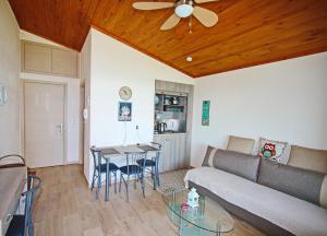 a living room with a couch and a table at Kallithea in Iraklitsa