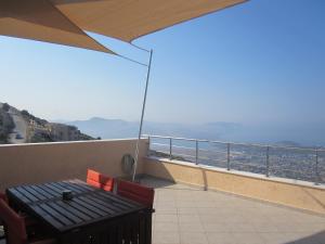 a table and chairs on a balcony with a view at Viva B&B in Anavyssos