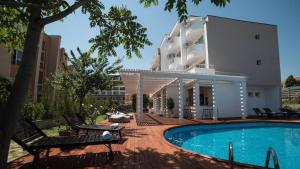 a building with a swimming pool in front of a building at The Mint Villa - Saint Vlas in Sveti Vlas