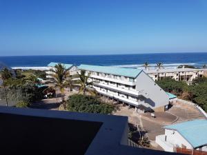 a view of a hotel with the ocean in the background at Ithaca Beach Resort in Margate