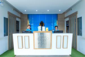 two women sitting at a counter with their laptops at Samui Resotel Beach Resort in Chaweng