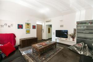 a living room with a couch and a tv at Villa Maria in Turin