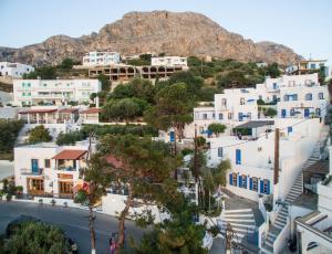 a view of a town with a mountain in the background at Aegean Home - Studios & Apartments in Masouri