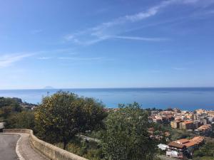 a road with a view of a city and the ocean at Rosy And Roby in Gasponi +12 photos