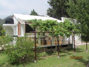 a house with a gazebo in the yard at Holiday Home Idyllic Cottage in Čanj